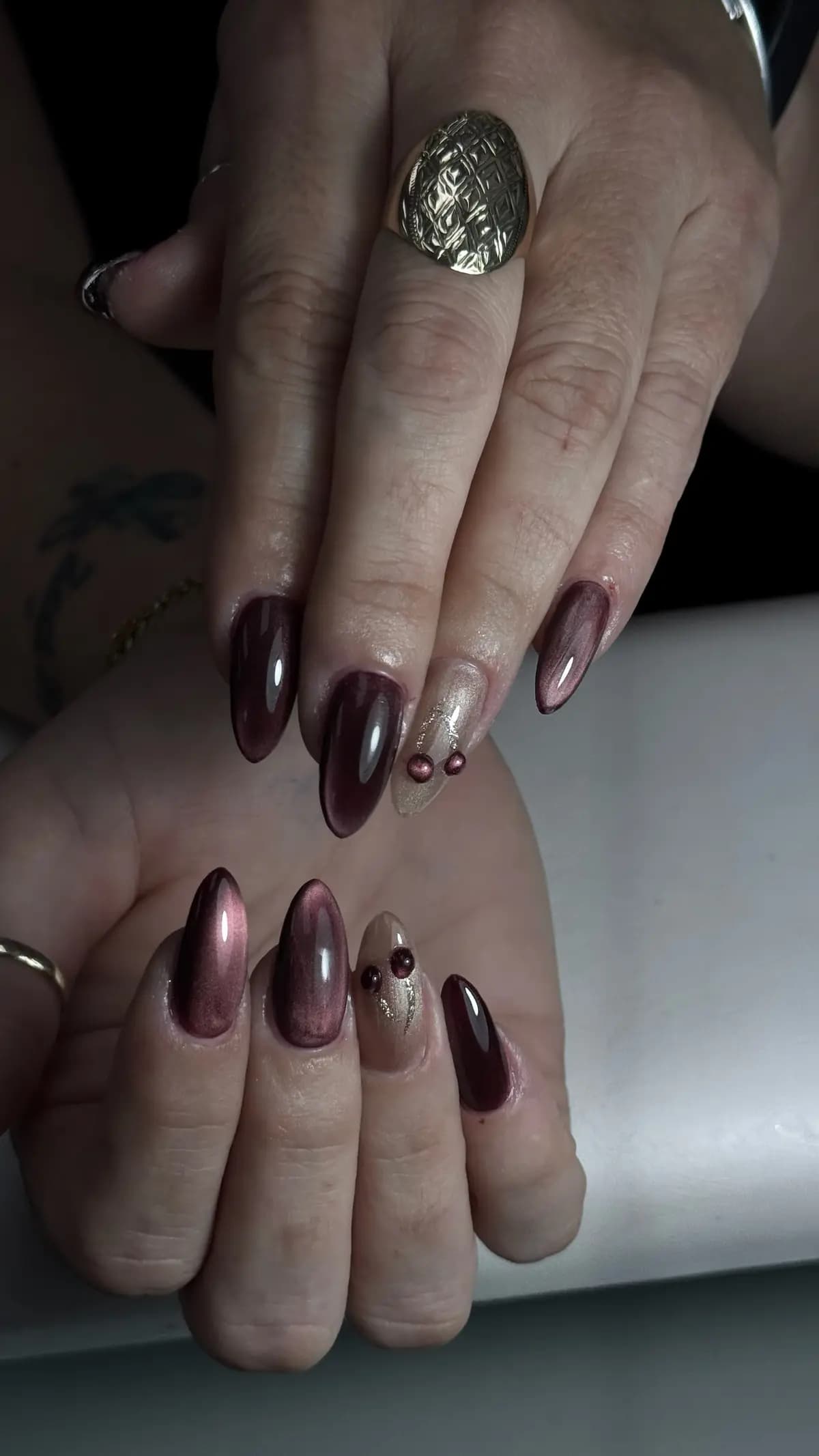 Burgundy chrome almond nails with gold dots