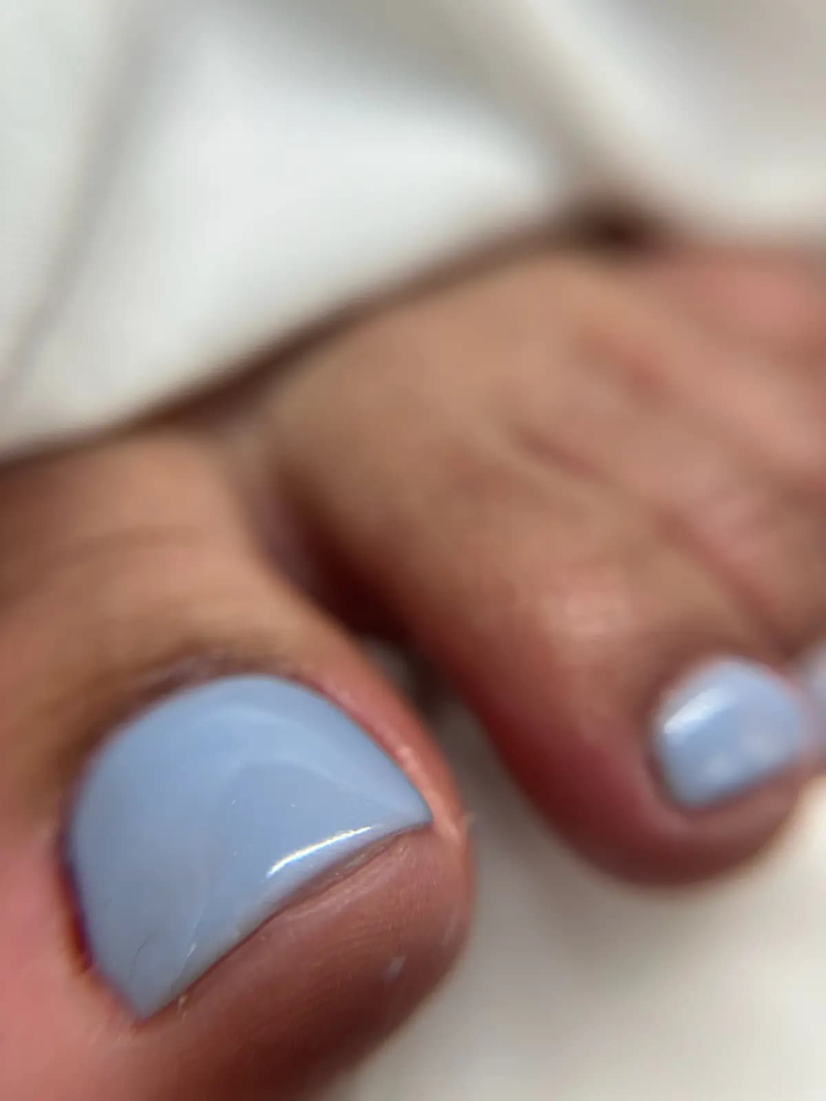 Lavender blue gel pedicure, close up of the big toe